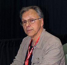 Chaykin seated at a table