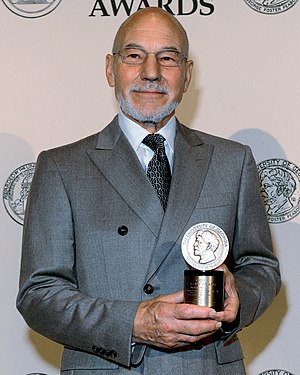 English actor Sir Patrick Stewart, seen here as the MC at the 71st Peabody Awards luncheon. Stewart's career has included roles on stage, television, and film. He has appeared for the Royal Shakespeare Company as well as in science fiction series such as Star Trek and X-Men.