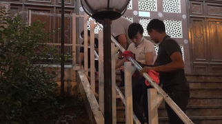 Police staff cleaning the mosque stairs not long after the incident