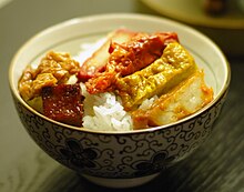 A bowl of rice topped with cubs of fake meat