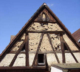 <span class="mw-page-title-main">Wattle and daub</span> Building technique using woven wooden supports packed with clay or mud