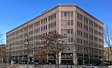 A five-story urban building in a downtown area