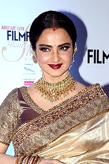 Rekha is looking at the camera.