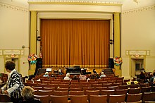 A theater with a yellow curtain