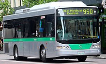 Silver and green bus