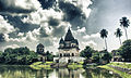 Image 26The pictured Shiva Temple is situated in Puthia Bazar of Rajshahi District. It was built on a hing plinth on the southern bank of a large tank. The temple is a 19.81 meter square building and total height is 35.03 meter. It is a Pancha Ratna type building consists of a Garbhagriha and a surrounding verandah. Rani Bhubanmoye Debi built this temple in 1823 AD. Photo Credit: Nasir Khan Saikat