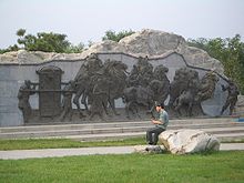 A modern sculptor's depiction of (the head of) a caravan approaching Beijing, complete with a camel-puller and a mounted caravan master, head cook, or xiansheng riding next to him. In the deserts of Mongolia, one would not see a dignitary in a sedan chair travelling along, nor would a baby camel accompany its mother. However, Mildred Cable and Francesca French in their book The Gobi Desert (1942) describe how a young camel can be carried in a wooden cradle on its mother's back. After the first week it is capable of walking beside her with periods of rest in the cradle; as it grows older it becomes capable of carrying a load of lighter articles needed by the caravan but at four years old can carry a full load. Lugou-Bridge-east-end-relief-3577.jpg