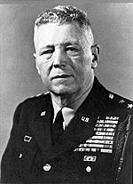 An aged Caucasian man in military uniform, with a large number of ribbons and medals