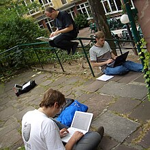 Three MediaWiki developers programming at the first Wikimania (Tim, Domas, and Jens). Photo by Brion Vibber.