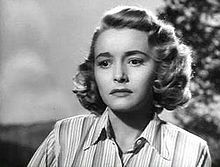 A black-and-white picture of Patricia Neal in a striped collared shirt