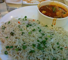 Vegetables in hot garlic sauce (top) with fried rice in India