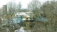 One of the two 12-inch gun positions and a fire control tower (at left) for Battery Gardner at Ft. Ruckman. Gardner-South-and-FCT.jpg