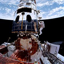 Musgrave and Hoffman prepare to install the new Wide Field and Planetary Camera, visible on the payload bay sill. STS061-105-004 EVA3.jpg