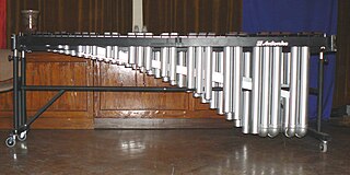 Marimba percussion instrument consisting of a set of wooden bars struck with mallets