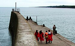 Gowned St Andrews undergraduates on the town pier. St Andrews gowns.jpg