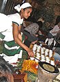 Image 12An Ethiopian woman preparing Ethiopian coffee at a traditional ceremony. She roasts, crushes, and brews the coffee on the spot. (from Culture of Africa)