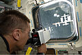 Astronaut Christopher Cassidy uses a rangefinder to determine the distance to ISS before docking