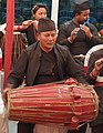 Newar man playing Pakhawaaja (Newar drum)