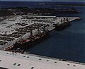 Ex-RVNAF A-37s and Hueys on a pier at Naval Base Guam