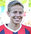 photo of Quinn smiling in red and blue soccer jersey with white trim around the neck