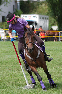 A young woman getting the mug during a Mug Shuffle game int he 4th round of the Swiss Mounted Pony Games 2013