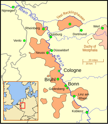 The territory is divided into nine sections; the main section borders the west bank of a wide river, and includes several important cities; other territories to the south and on the east bank of the river, are considerably smaller, and a crescent of territory south of Linz. Further north is a small section, still on the river, but separated from the main part of the territory. East of this section is "Vest Recklinghausen", and east of that is the Duchy of Westphalia. Nearby cities are, to the west, Nijmegen and Venlo, and to the east, Duisburg, Düsseldorf, and Dortmund. A big dot marks the location of Cologne, but it is distinguished from the territory by a border.