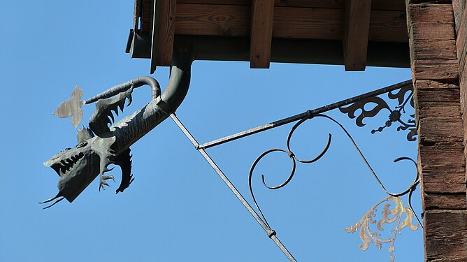 Dragon-shaped drain spout on a roof in St.Leonard, Switzerland