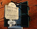 Sign on northern facade noting architect and date