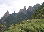 Forested mountains topped by rocks.