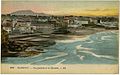 Postcard of a coastal scene with the ocean on the right and a city on the left