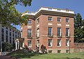 Photograph of the Octagon House on a sunny winter day, with more modern buildings behind.