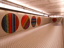 An empty hallway. On the walls and floors are mosaic circles