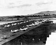 Long rows of planes being secured after the days flights, dot the entire length and breadth of the now fully completed runway #11 Ewa 145092.jpg