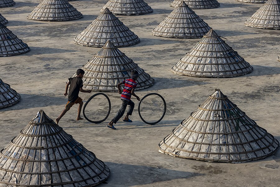 Children playing in the rice mill by Azimronnie.