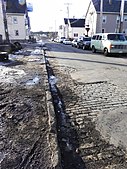 Setts visible beneath cracked asphalt in New Bedford, Massachusetts, United States