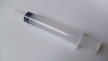 Syringe with a curved tip for cleaning socket Syringe 2.jpg