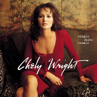 A woman in a red dress, seated on a brown couch. The text "Chely Wright" is in a white stylized font over the center of the image, with the text "Single White Female" near the top right.