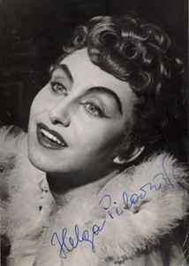 1950s glamour publicity shot of a woman about 30 years old in stage makeup, furs, and tightly-curled hair