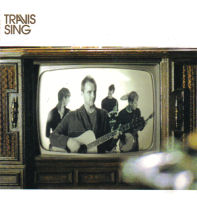 The four members of the band Travis are displayed on a black-and-white television screen. Fran Healy stands in front, playing a guitar. Andy Dunlop is behind him and to the right, playing a banjo. Behind and to the left of Healy is Dougie Payne, who is looking at Neil Primrose, in the back-center, playing a drum set.