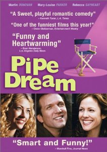 "Pipe Dream" is written in yellow next to a movie set folding chair. Below are three photos, side by side, of smiling thirty-somethings : a blonde woman, a man and a dark-haired woman.