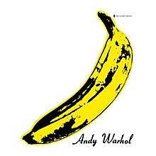 On white, a painted banana in the style of Andy Warhol, signed by the artist, with directions (in small text) to "peel slowly and see"