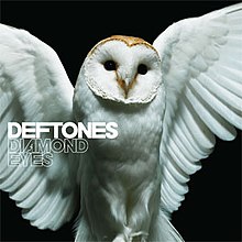 A barn owl is shown with its wings open in front of a black background. On the complete left side of the border, the words "Deftones" and "Diamond Eyes" are shown.