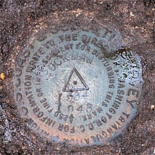 The geodetic disk (PID MY0039) set in the ground above the galleries of Battery Gardner at Fort Ruckman. Its approximate position is marked on the map above. MY0039-Ruckman-Disk.jpg