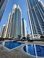 Outdoor pools and sunbathing area for residents