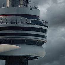 A man sits on the CN tower with a cloudy sky on the background.