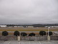 Location of crash of Flight 105 is along runway, perpendicular to the space between the two groups of hangars, slightly to the left of the white parking deck light pole in foreground. Runway 18-36 was extended south after the accident and Village Creek routed through tunnels.