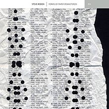 Depicts a crumpled and hole punched page. Only the right edge of the paper is visible which is torn ragged. The page covered with numbers and letters.