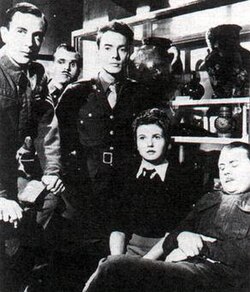 Gibbs, Johnson and Smith
The Seven Sisters Soldier is standing behind Peter & Bob and Sergt. 'Stuffy' (Graham Moffatt) is asleep ACT Characters.jpg