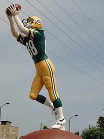 A large statue of a Packer catching a football.