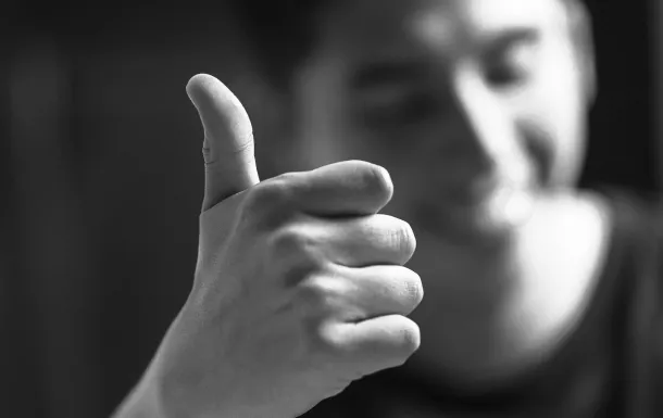 Close-up of a man giving thumbs up